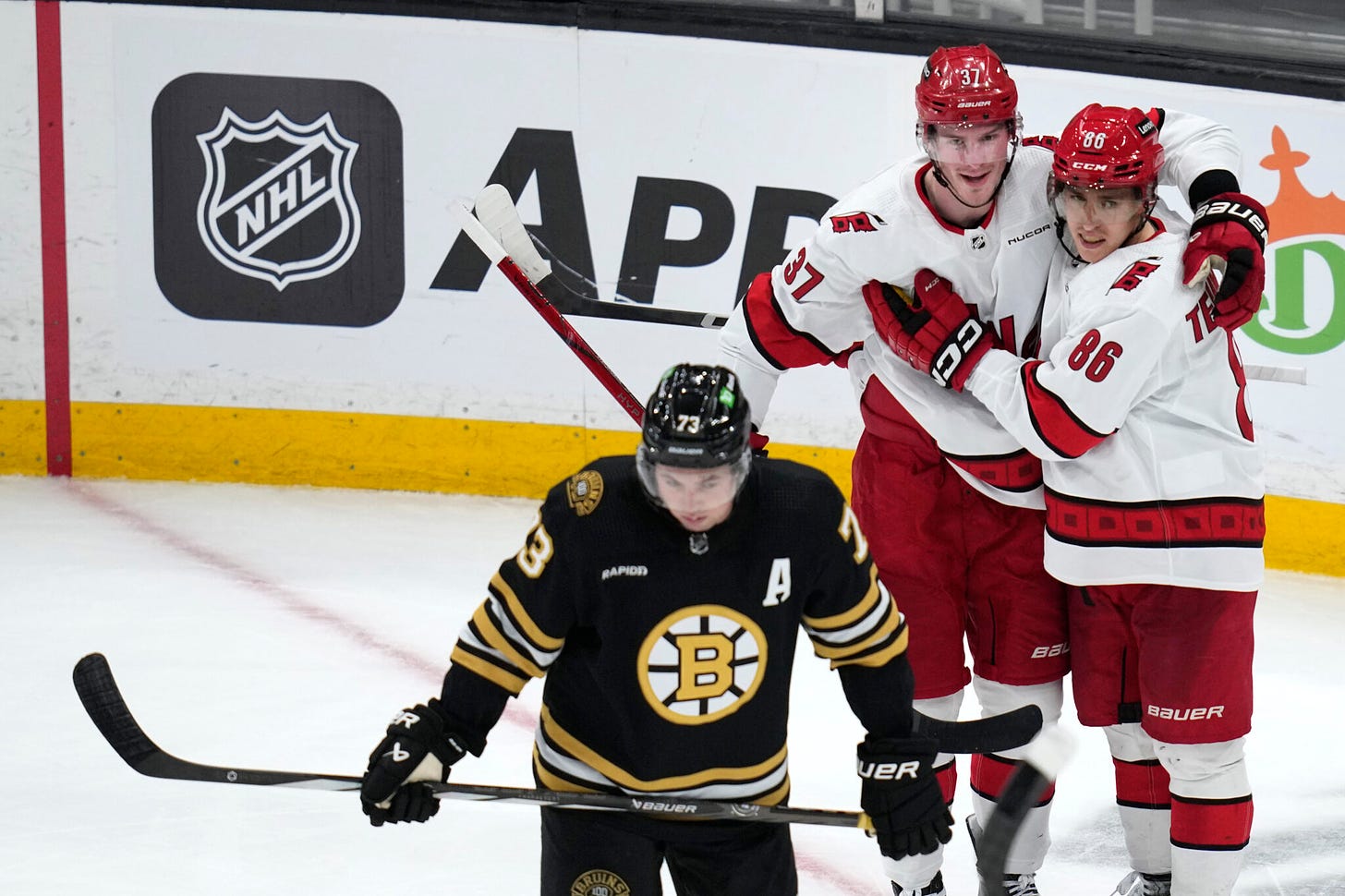 Andrei Svechnikov celebrates scoring a Michigan goal while a Bruins player skates off.