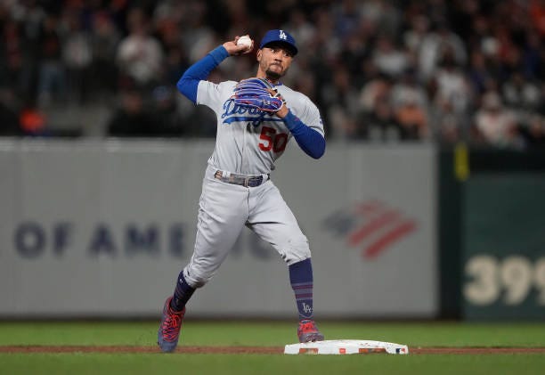 Mookie Betts of the Los Angeles Dodgers throws to first base to complete the double-play against the San Francisco Giants in the bottom of the six...