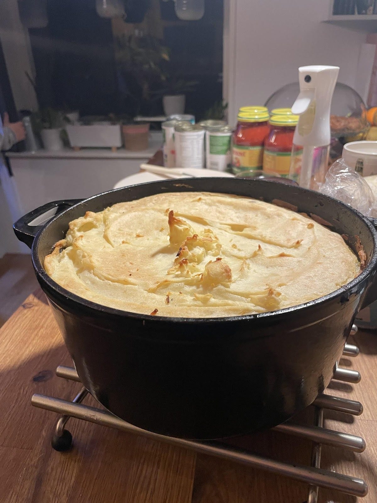  A Dutch oven filled with Cottage Pie / Pastel de Papa. The mashed potatoes are cooked till crispy.