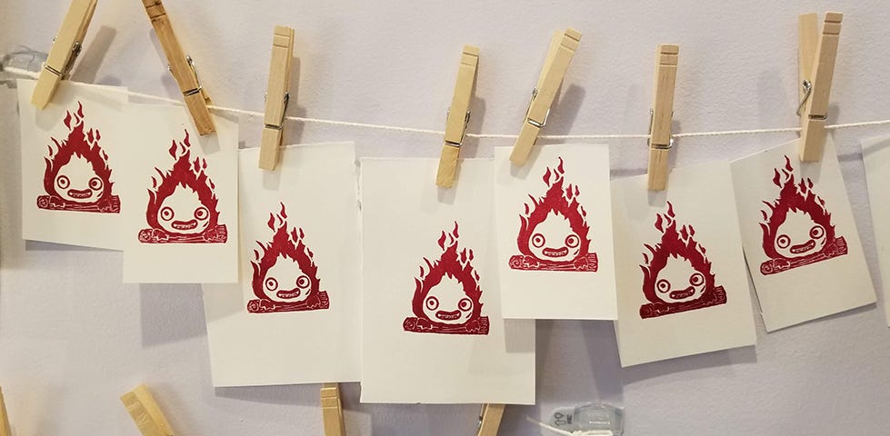Seven mini prints of the fire demon, Calcifer, from Howl's moving castle.