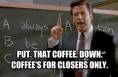 This may contain: a man in a suit pointing at a blackboard with writing on it that says, put that coffee down coffee's for closer only