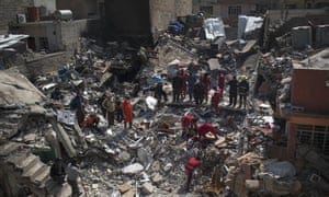 Civilian rescue teams work on debris from a destroyed house in Mosul.