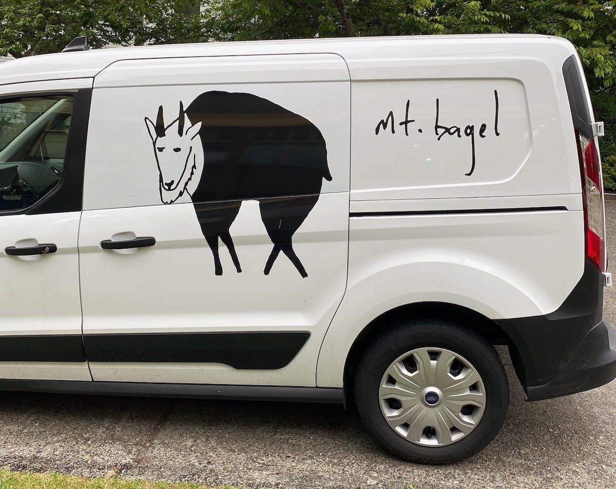A delivery van with the Mt. Bagel logo.