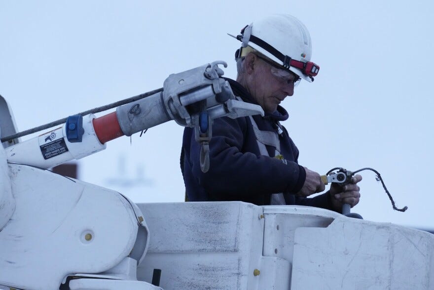 Central Maine Power Co. lineman John Baril works to restore electricity, Wednesday, March 15, 2023, in Lewiston, Maine.