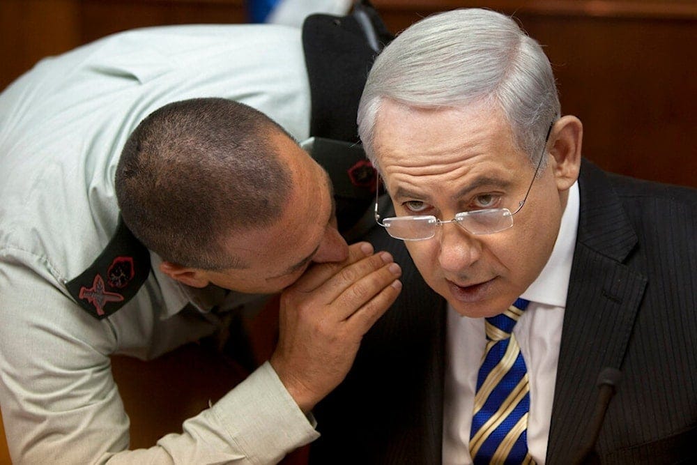 Israeli occupation PM Benjamin Netanyahu, speaks with then Military Secretary Eyal Zamir during weekly cabinet meeting in his occupied al-Quds office, occupied Palestine, June 2, 2013. (AP)