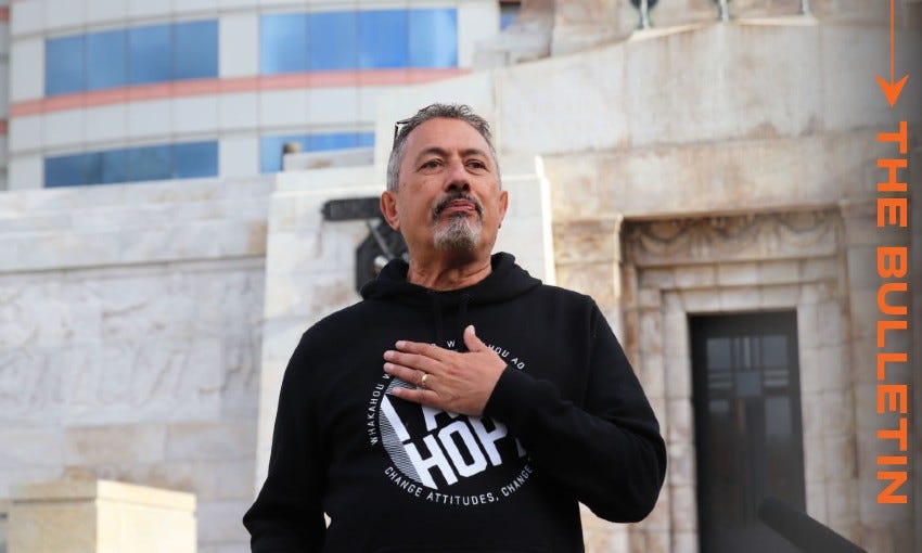 Mike King wearing an I Am Hope hoodie with his hand on his chest