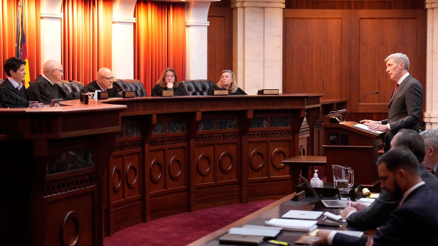 Attorney Eric Olson, far right, argues before the Colorado Supreme Court on Wednesday, Dec. 6, 2023, in Denver.