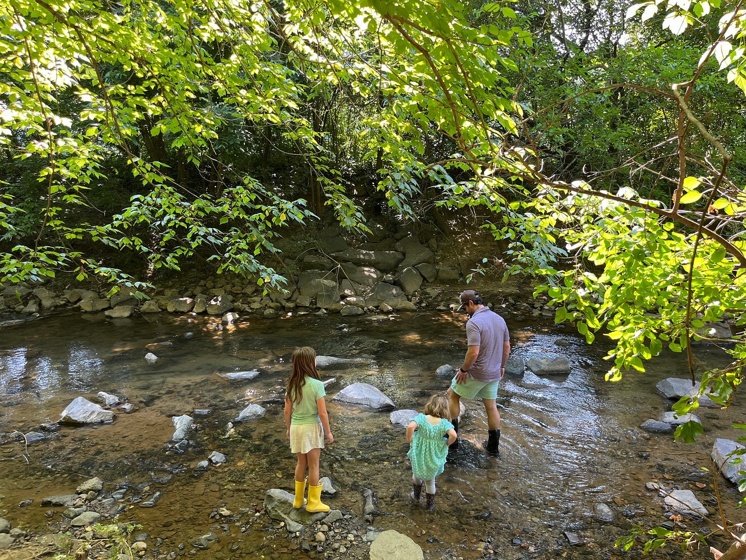two children and a man wading into Little Sugar Creek, Charlotte, North Carolina