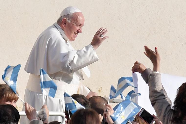 Pope Francis waves to pilgrims holding flags of Argentina as he arrives for the weekly general audience on November 27, 2019 in St. Peter's Square at the Vatican.