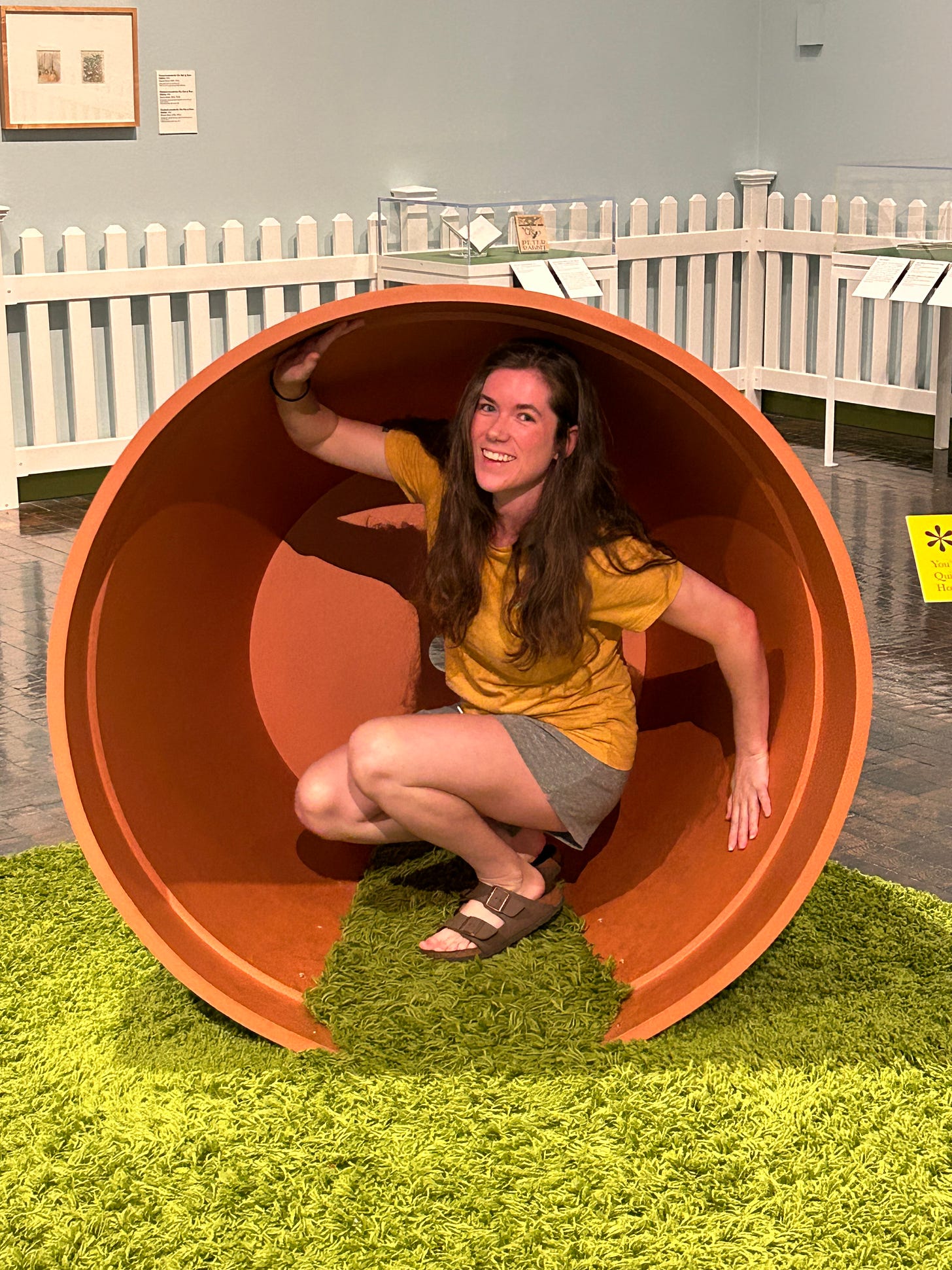 Kayla Stark in a giant terra cotta pot at the Beatrix Potter exhibit