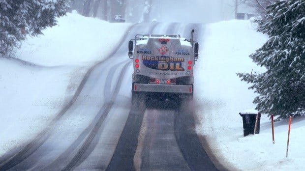 The authors write that a full 87% of New England households rely on electricity for heat during the cold winter months, whether that means natural gas furnaces, heating oil tanks or heat pumps. Above, a home heating oil delivery truck climbs a snow covered road, in Derry, N.H. last year. (AP Photo/Charles Krupa, File)