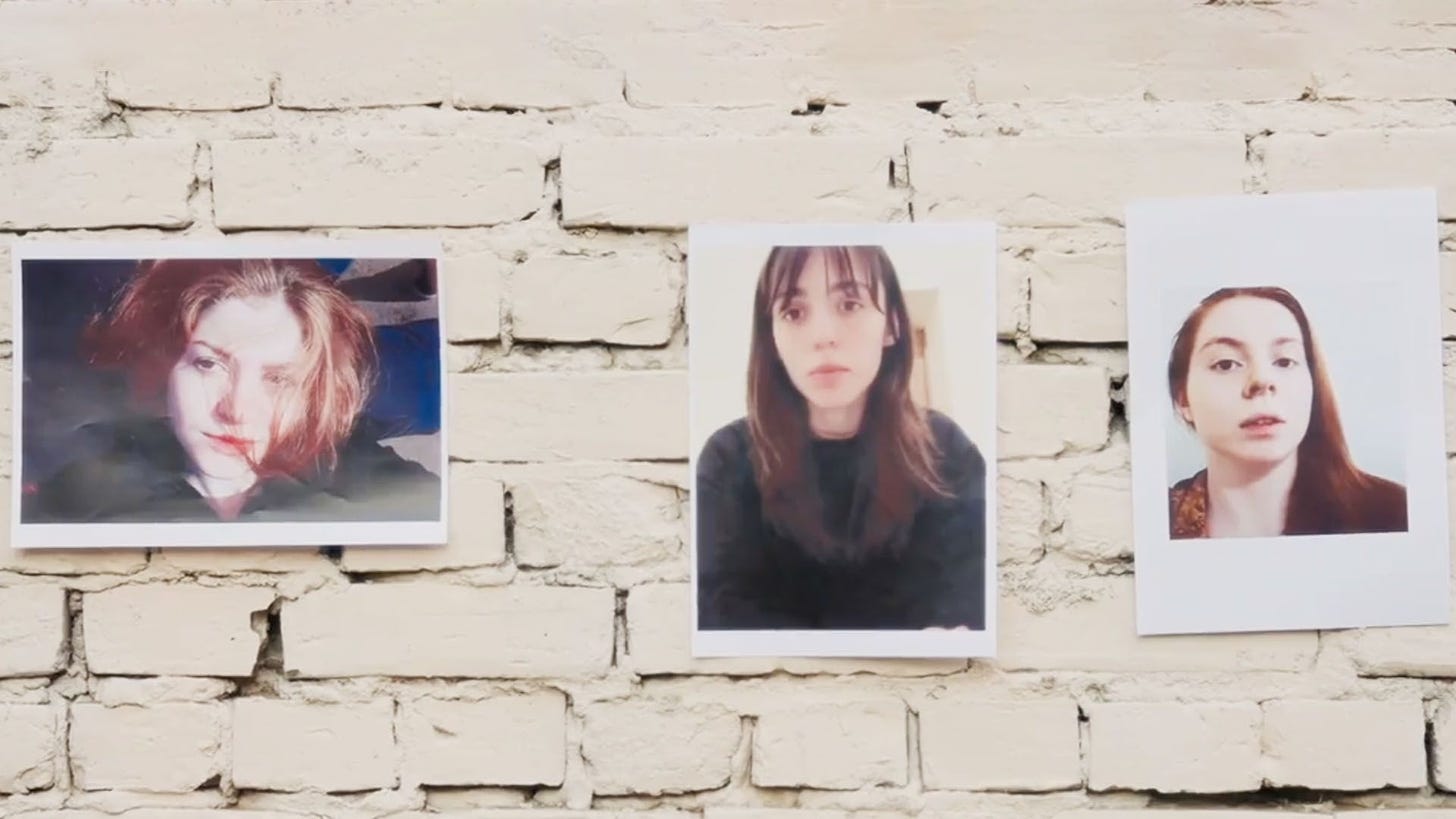 Brick wall with printed photos of the 3 Chechen women who escaped, whose stories are told here