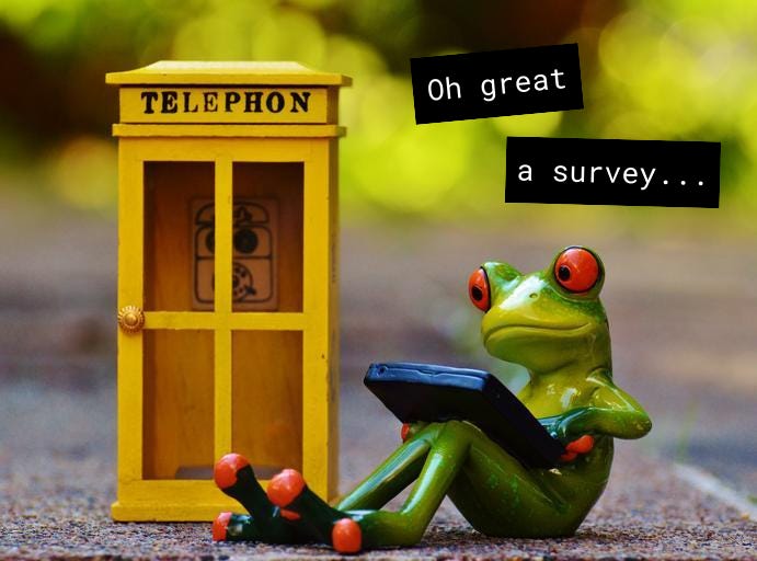 A toy frog on an electronic tablet next to a toy telephone booth with text that says "Oh great a survey"