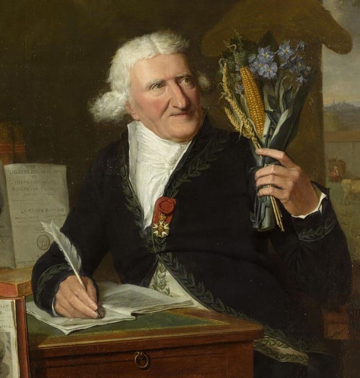 An elderly man in a powdered white wig sits at a desk writing with one hand, and holding aloft a bouquet of potato flowers and other food sources with the other. Does his face vaguely resemble a potato? Perhaps just the merest little bit. 