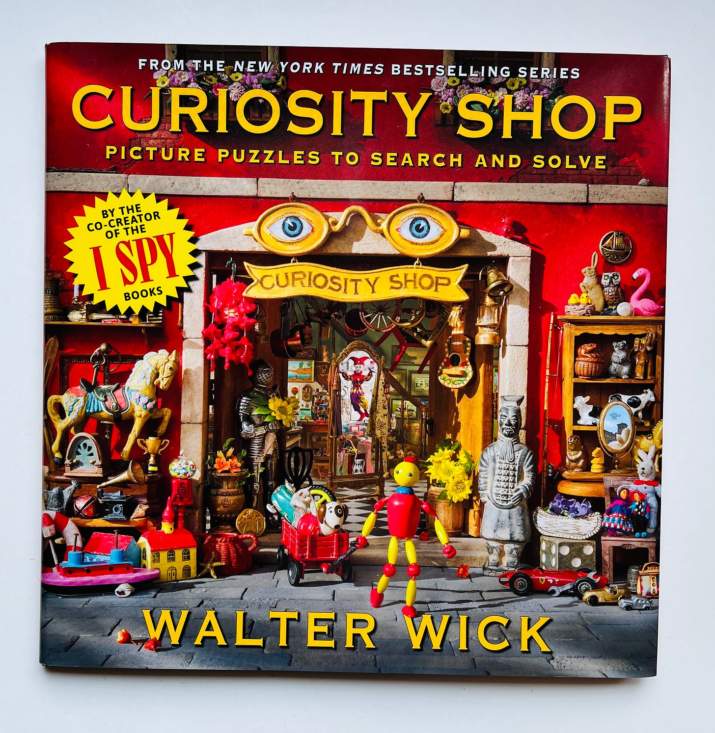 The cover of Walter Wick's new book, with many tiny items and a red and yellow pose-able man front and center