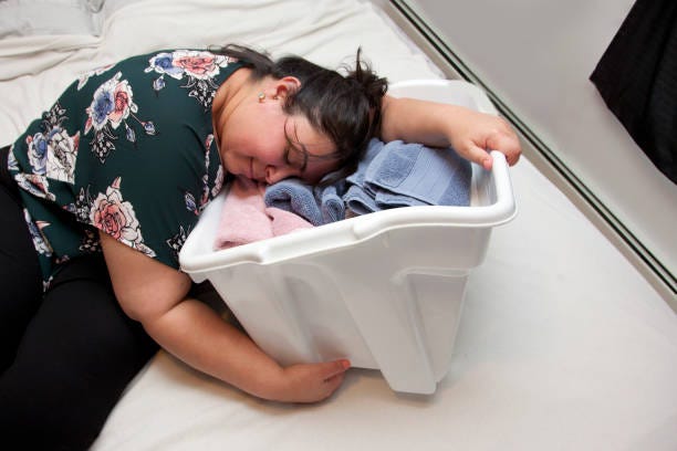 Tired Mom Asleep In The Laundry Stock Photo - Download Image Now - Mother,  Tired, Emotional Stress - iStock