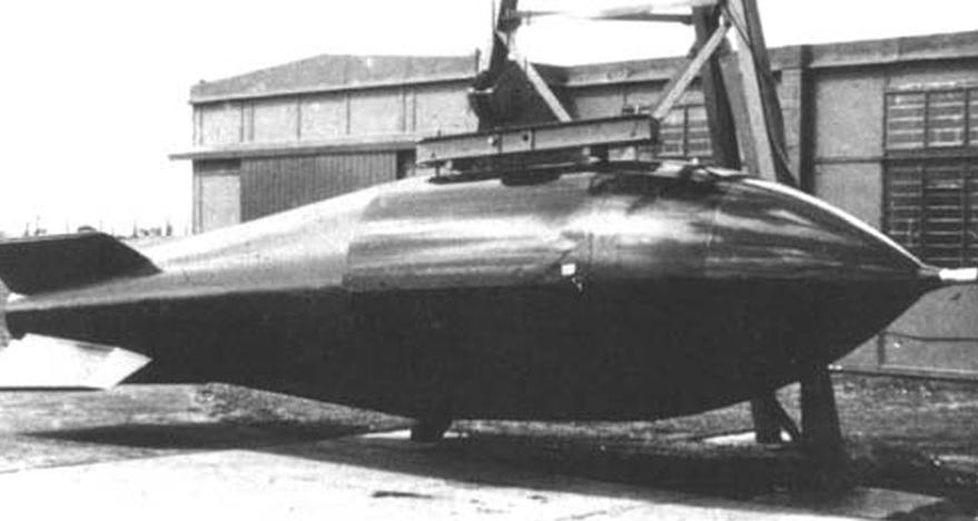 A black and white photo of a Blue Danube atom bomb designed to be dropped from a Vickers Valiant B.1 aircraft (part of the very stylish V-Bomber fleet). It's a classic "fat" bomb shape, with a blunt pointy tip and an elongated tail with find attached.