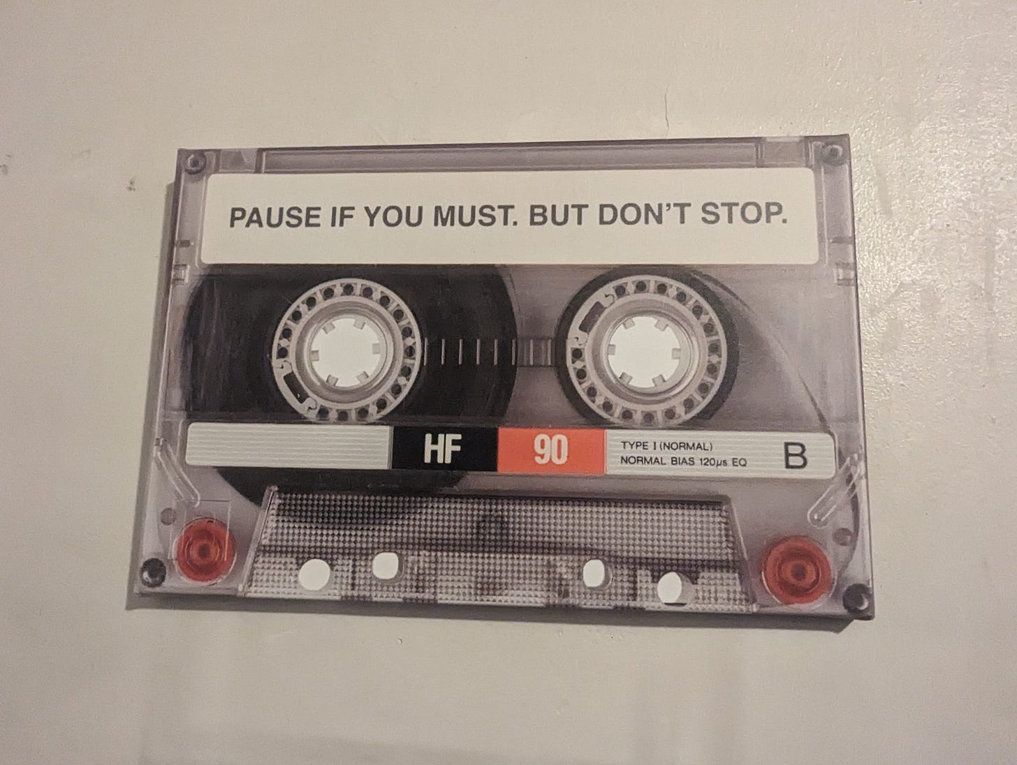 A photo of a cassette tape that reads: Pause if you must. But don’t stop.