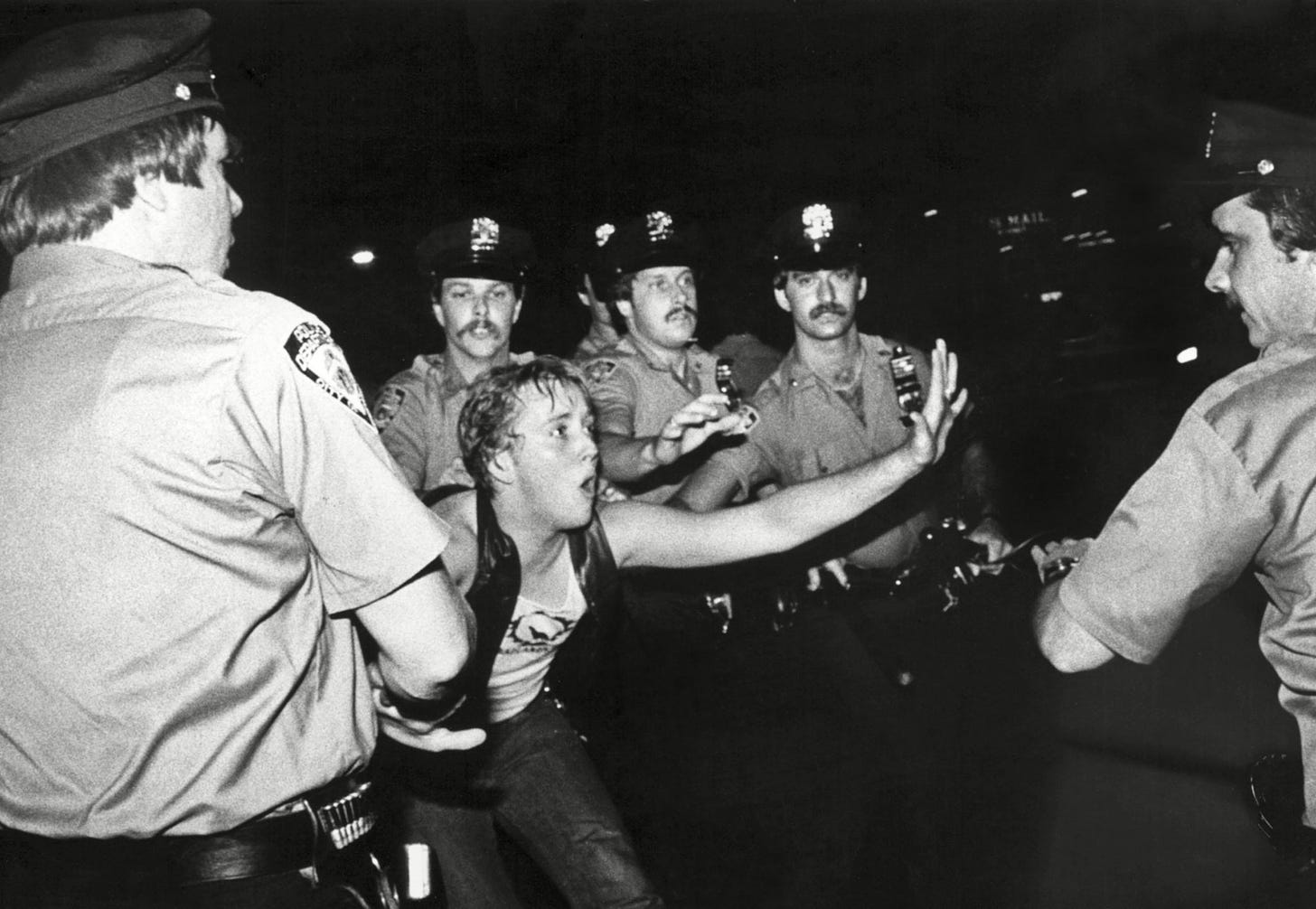 Police detain and beat a protester at the Stonewall riots