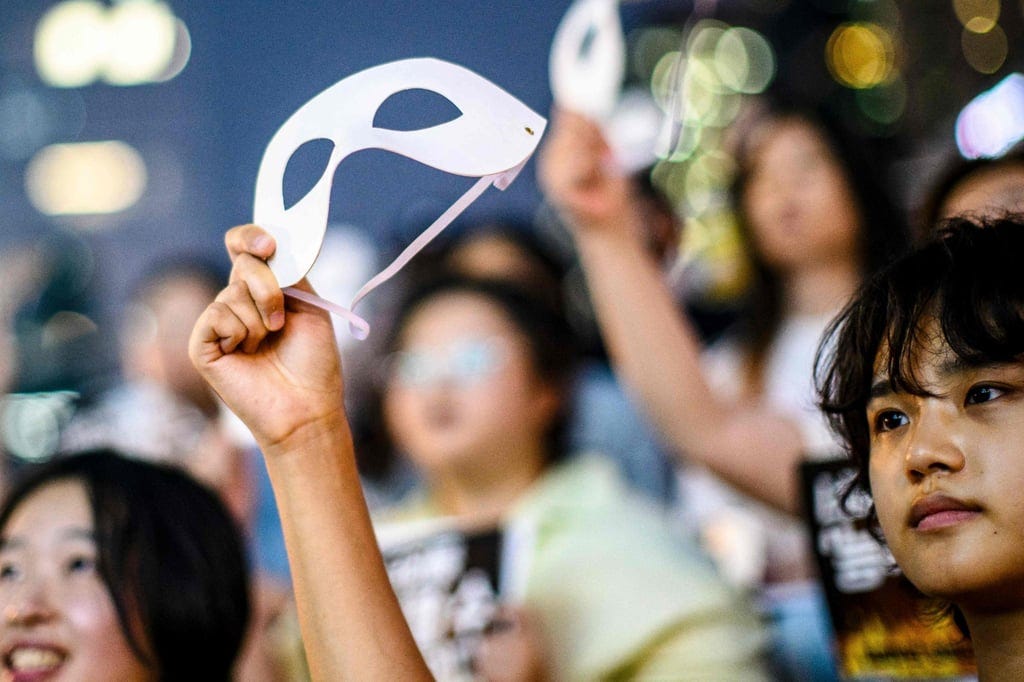 Activists holds eye masks during a protest against deepfake porn in Seoul on August 30. Photo: AFP