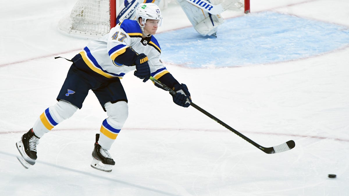 Torey Krug passing the puck during a game.