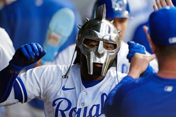 Jackie Bradley Jr. #41 of the Kansas City Royals is congratulated in the dugout by teammates after hitting a home run during the fifth inning against...