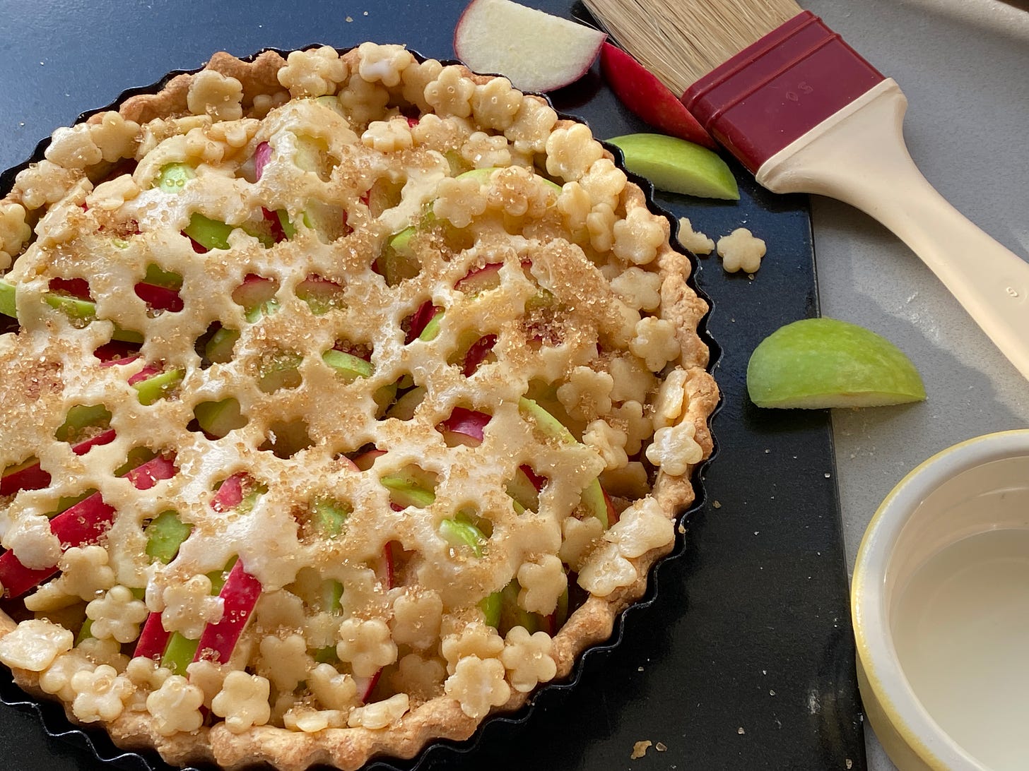 Rhubarb and Apple Tart with a slice cut out and served with custard on a plate.