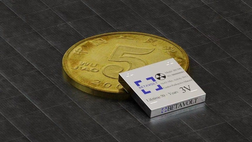 A tiny nuclear battery rests against a Chinese coin.