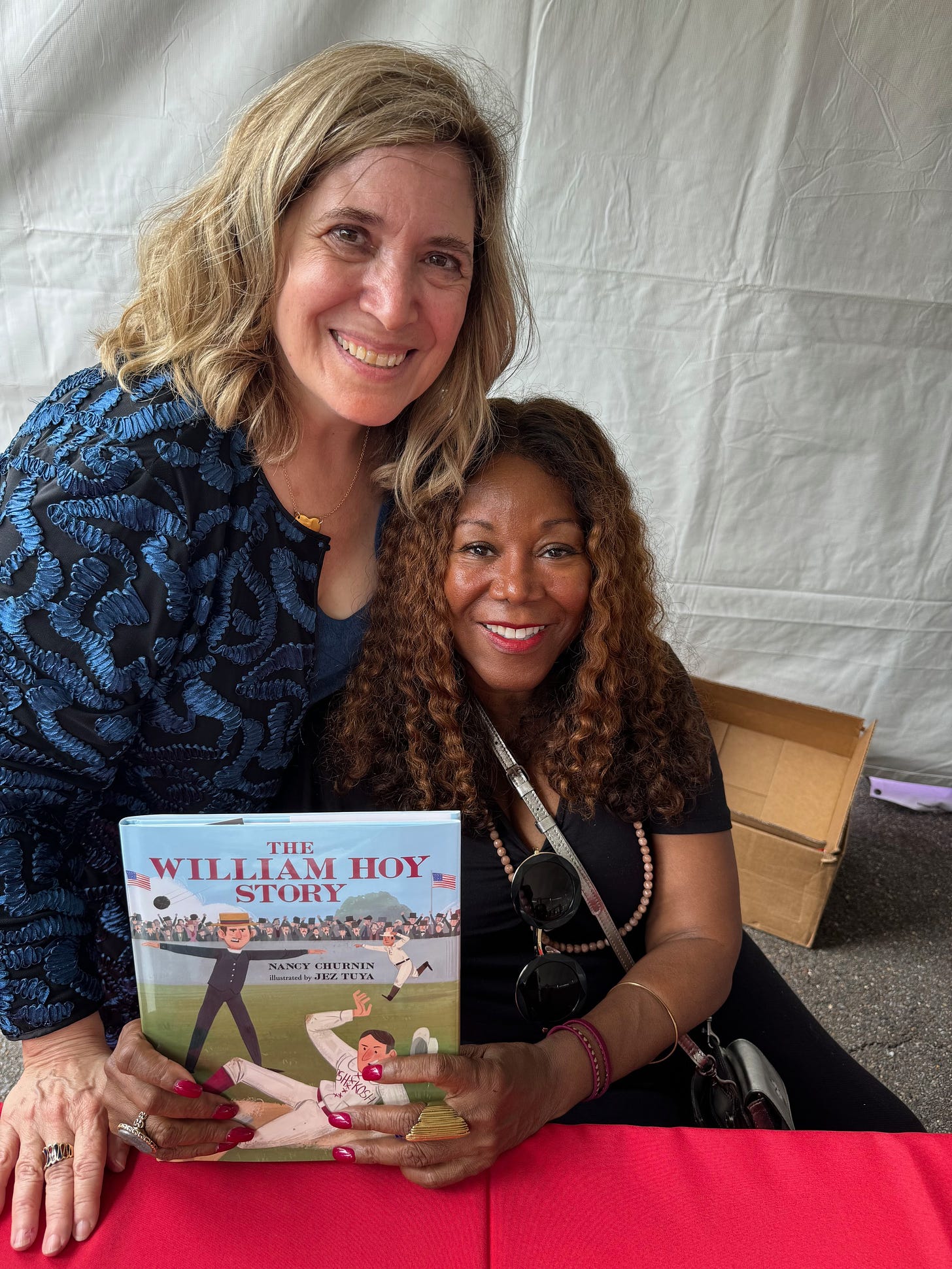 Author Nancy Churnin with Ruby Bridges and The William Hoy Story book.