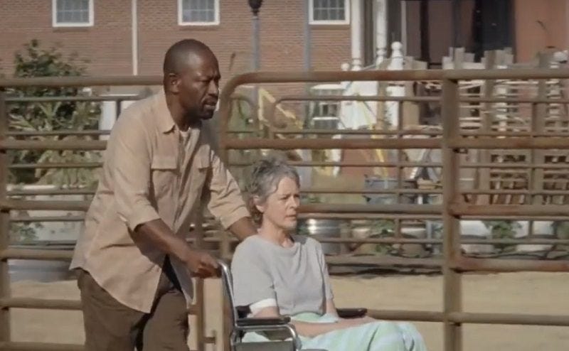 the walking dead morgan pushing carol in wheelchair 702