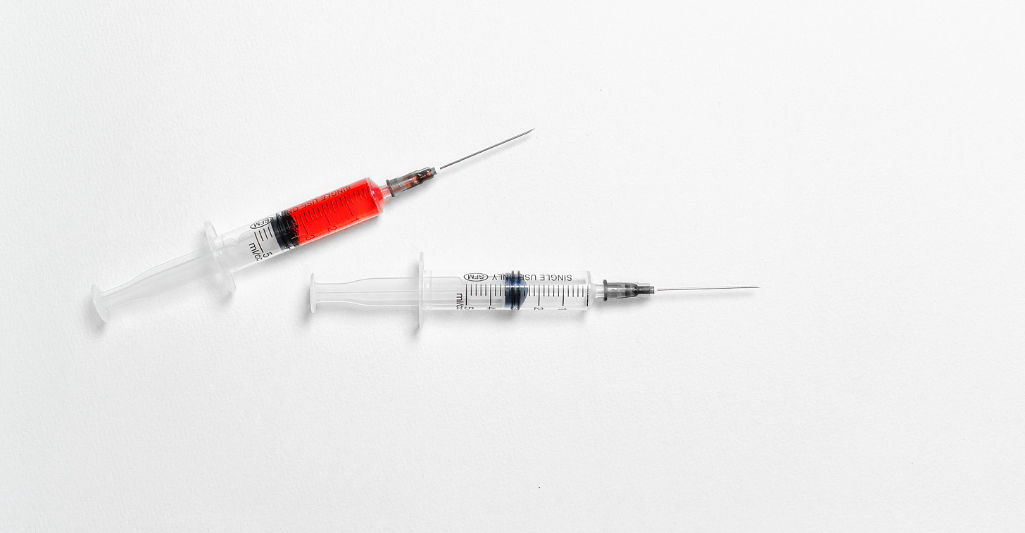 Two syringes on a white background