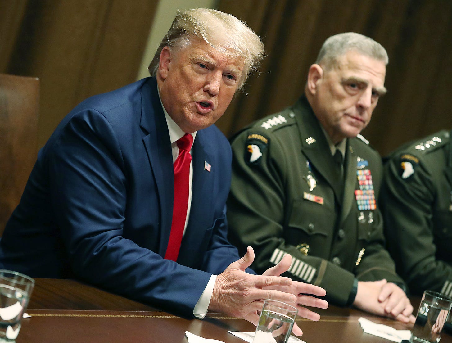 Then-President Donald Trump speaks as Joint Chiefs of Staff Chairman Mark Milley looks on after a briefing from senior military leaders at the White House on Oct. 7, 2019, in Washington, D.C. Photo by Mark Wilson/Getty Images