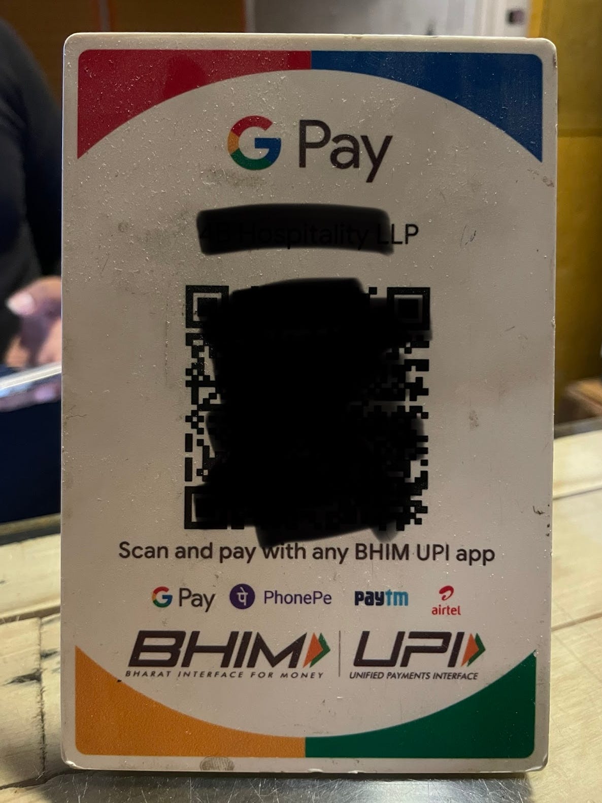 A hotel placard with a blacked-out QR Code allowing India guests to pay for the hotel using Google Pay, PhonePe, PayTM, and several others