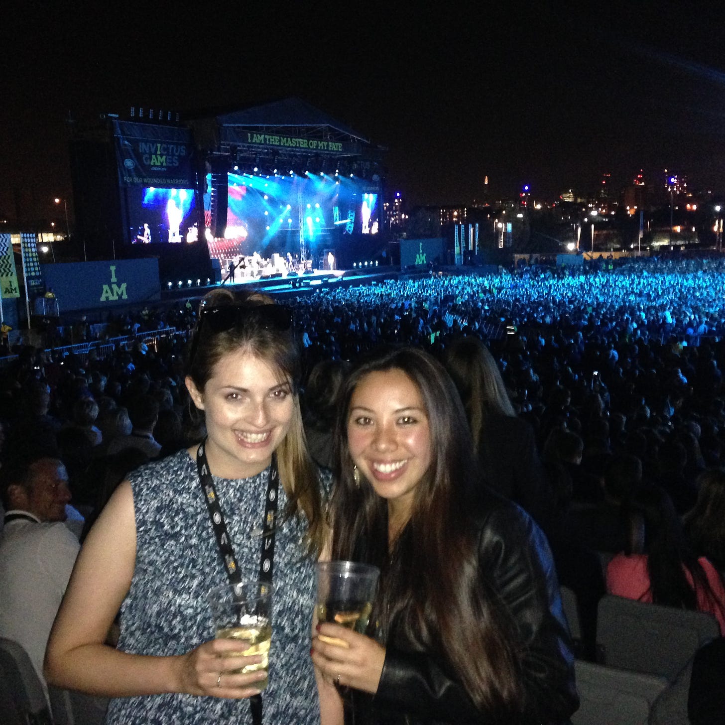 Ainhoa Barcelona and her colleague smiling and holding drinks at the 2014 Invictus Games closing concert in London