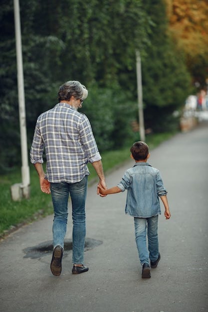 Free Photo | Boy and grandfather are walking in the park. Old man playing  with grandson.