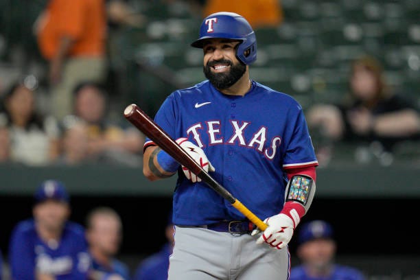 Sandy Leon of the Texas Rangers smiles as he bats against the Baltimore Orioles during the ninth inning at Oriole Park at Camden Yards on May 26,...