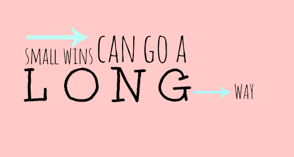 Pink background with two blue arrows and text “small wins can go a long way.”