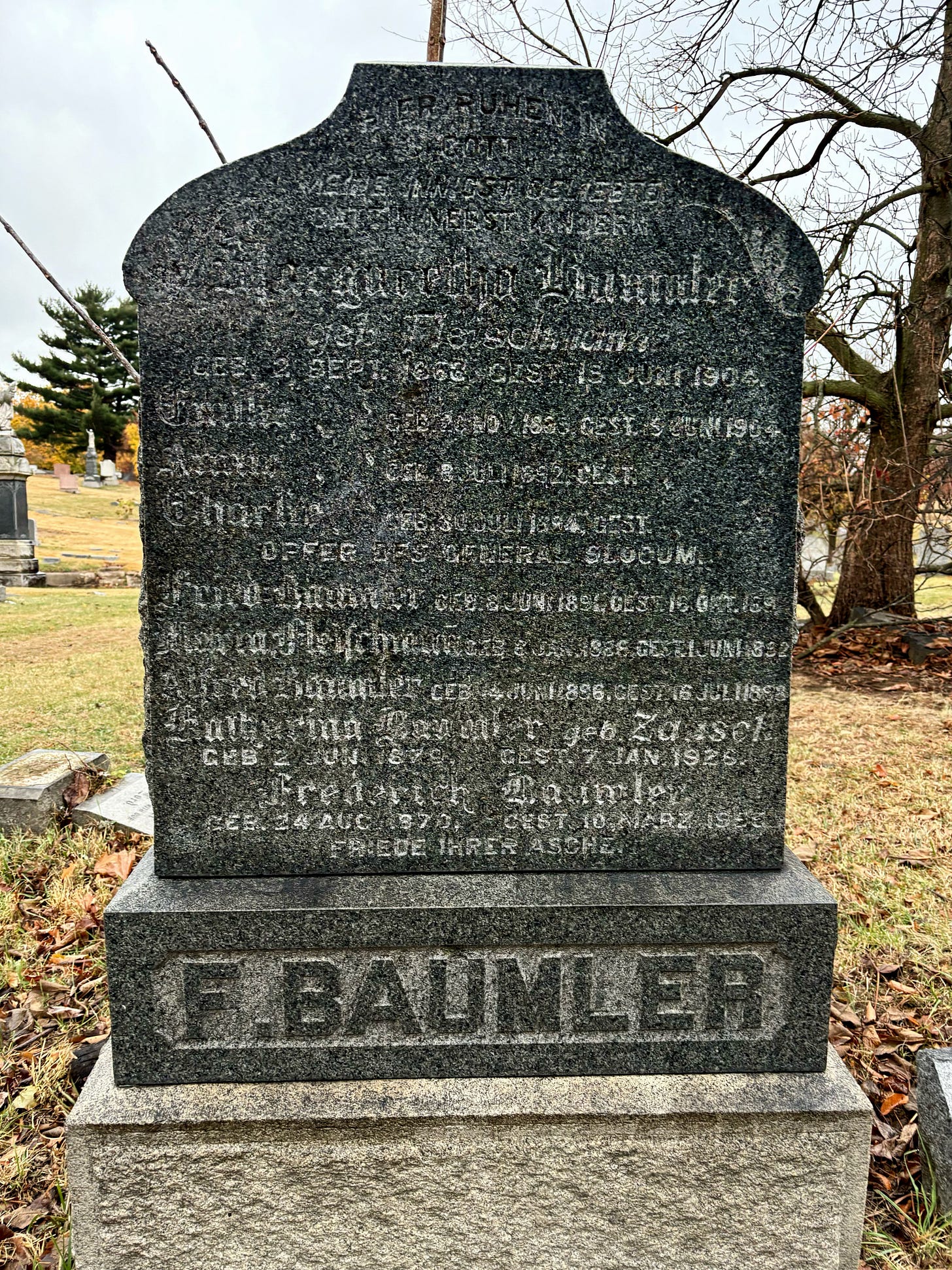 The Baumler family headstone, difficult to read with age but the first names all share the same death date: Jun 15 1904.