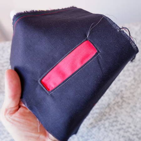 showing the topstitching all around the welt pocket opening