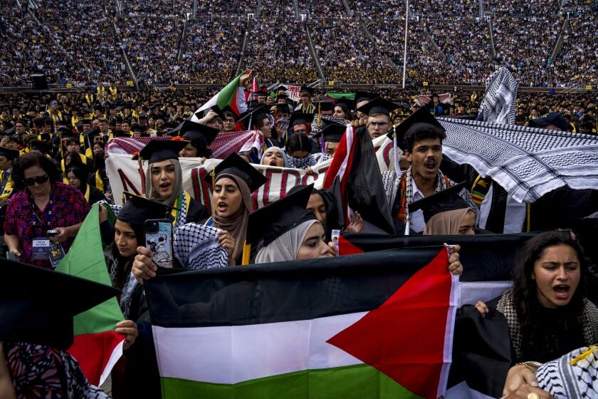 Students demonstrate during a Pro-Palestinian protest during the University of Michigan's spring commencement ceremony on May 4, 2024 at Michigan Stadium in Ann Arbor, Michigan. A group of students called for the University of Michigan to divest from companies with ties to Israel during the spring commencement ceremony.