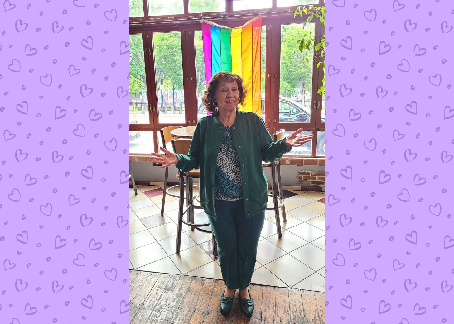 Nana standing in front of a pride flag