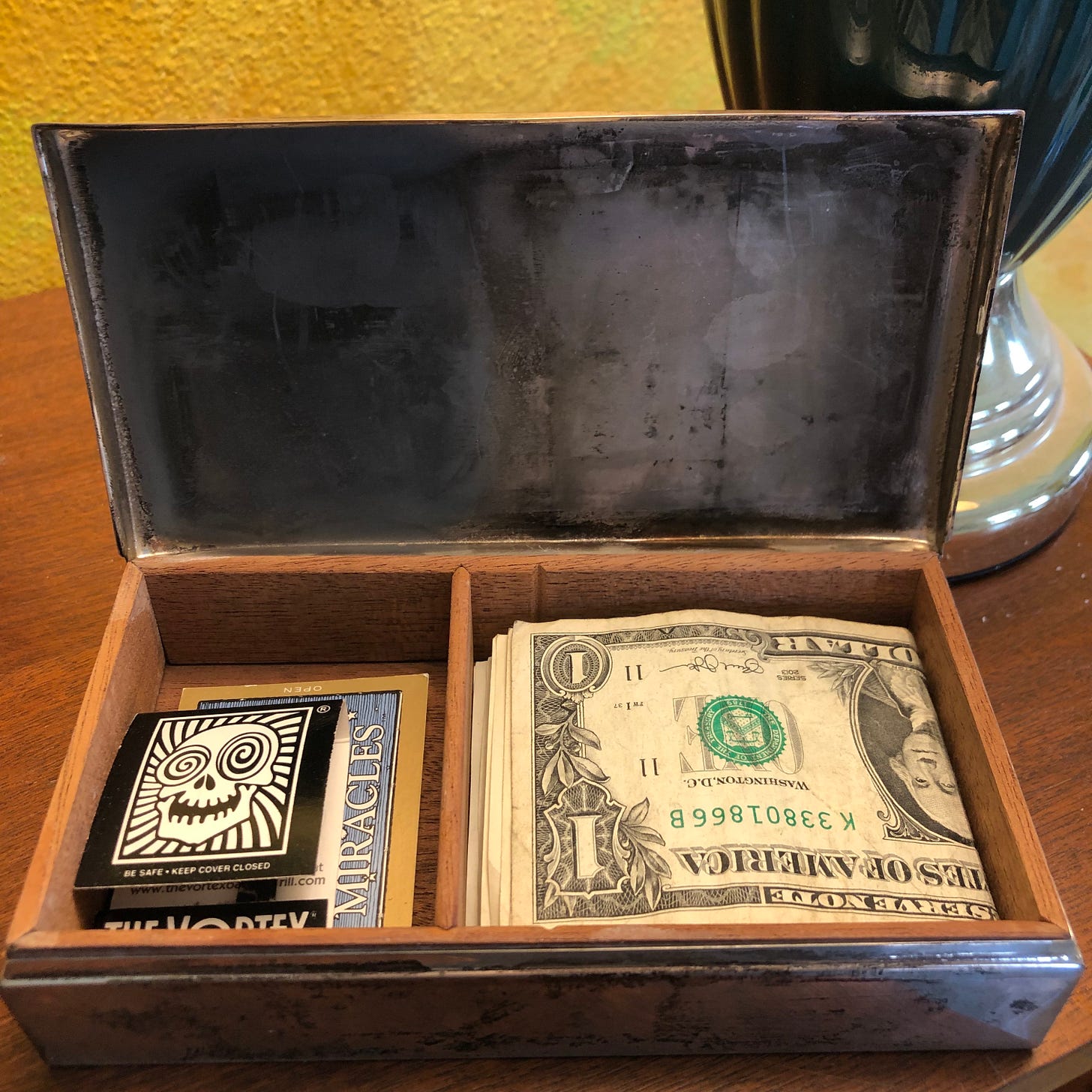 Open box showing dollar bills and matches