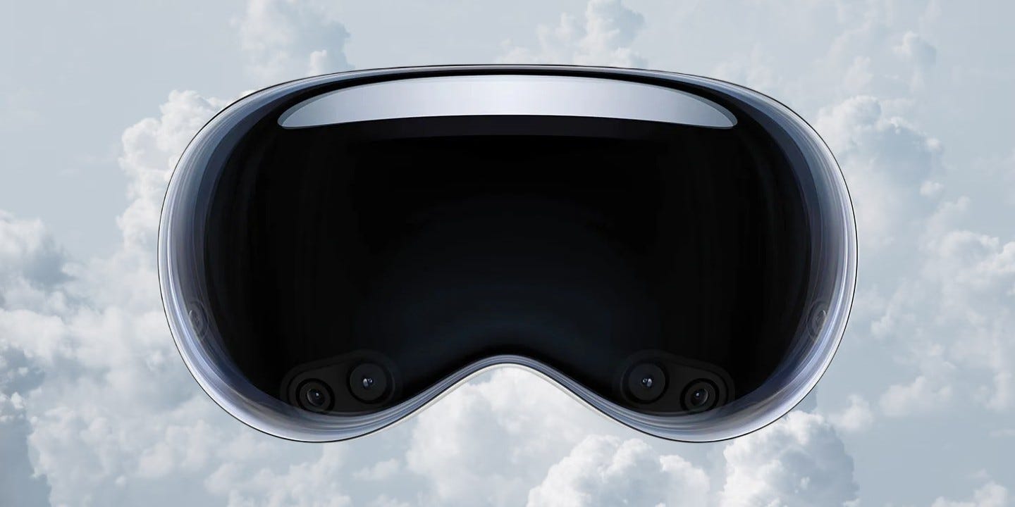 A large glass headset (the Apple Vision Pro)