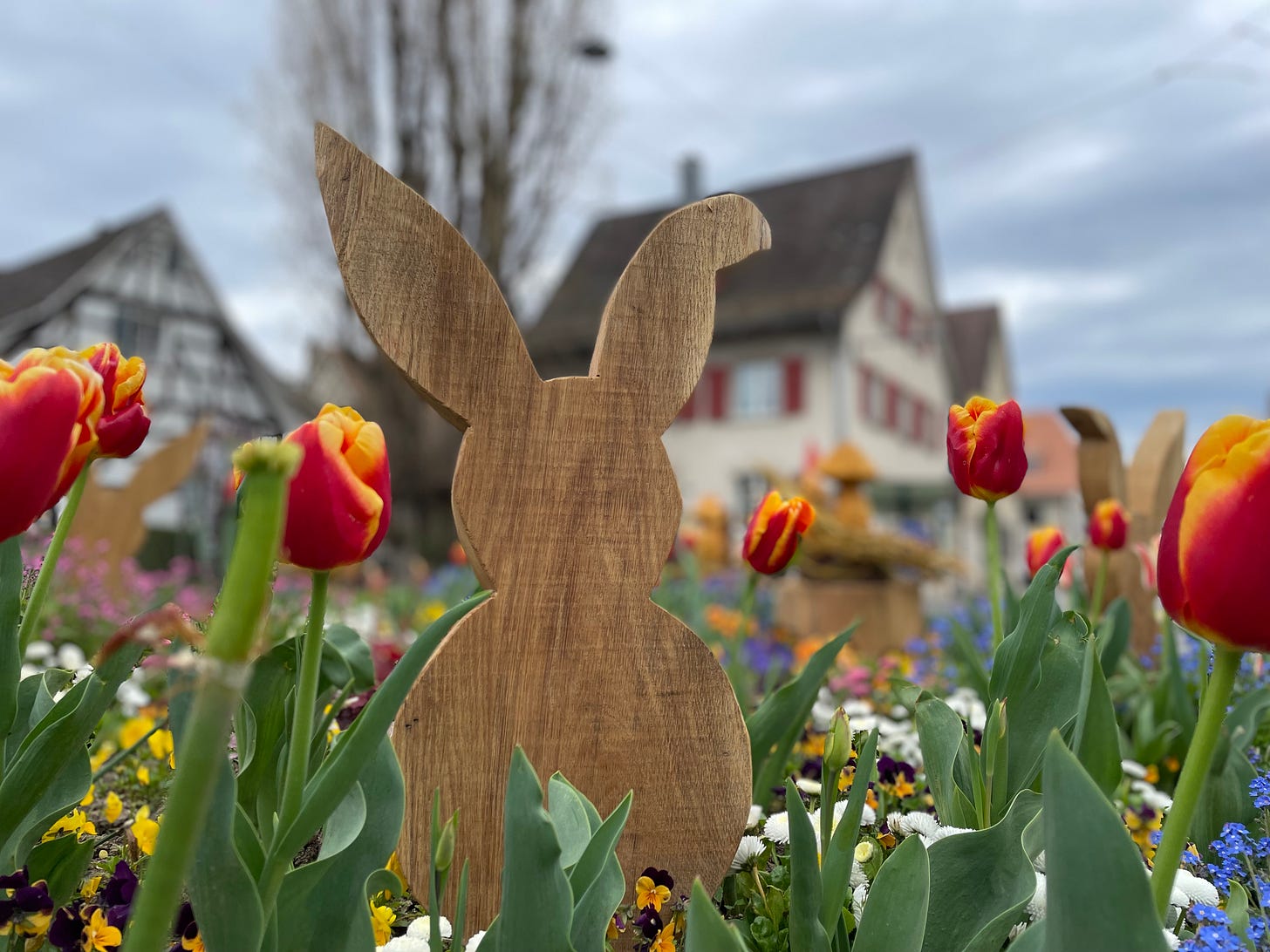 A wooden rabbit silhouette surrounded by tulips