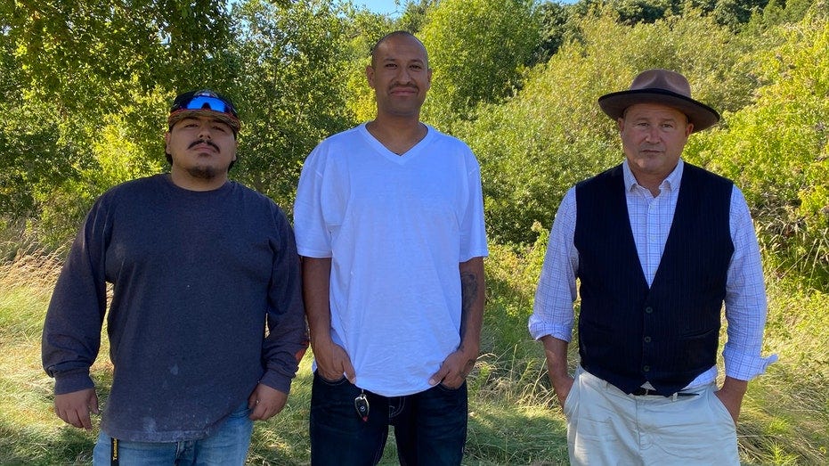 Complainants Gary and Rickey Hernandez and former St. Helena Mayor Geoff Ellsworth in front of greenery in Napa Valley