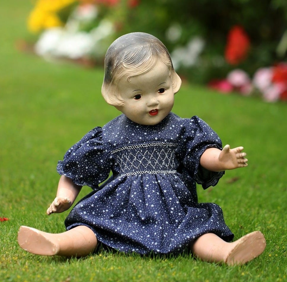 plastic girl doll sitting outdoor