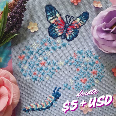 A cross stitch project stitched in Trans pride colors showing a caterpillar, looking upwards while a wave of star and heart motifs swirls upwards to a butterfly.  Donate $5+