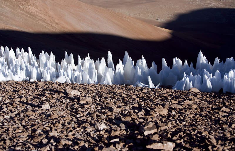 A row of the ice form called penitentes, looking like the pointed white hats of the Ku Klux Klan.