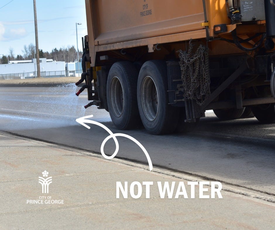 A City truck spraying liquid onto the road. A graphic arrow points to the spray. Graphic text reads: NOT WATER