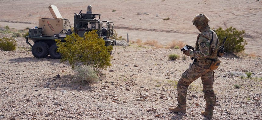 U.S. Army Pfc. Darren Campbell, infantryman assigned to the Alpha Company, 1st Battalion, 29th Infantry Regiment, 316th Cavalry Brigade, operates a ground robot during the human machine integration experiment for Project Convergence – Capstone 4 in Fort Irwin, Calif., March 11, 2024.